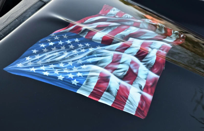 a sticker on the hood of a car with the american flag