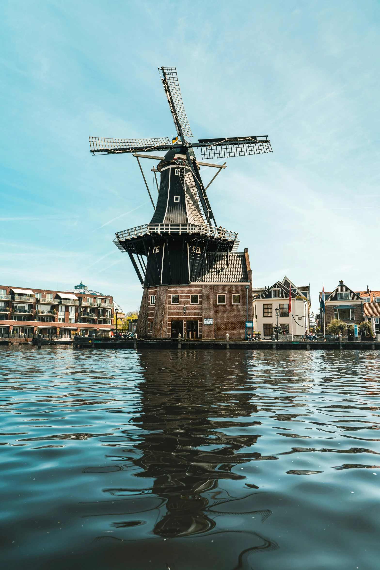 a large windmill in the middle of a lake