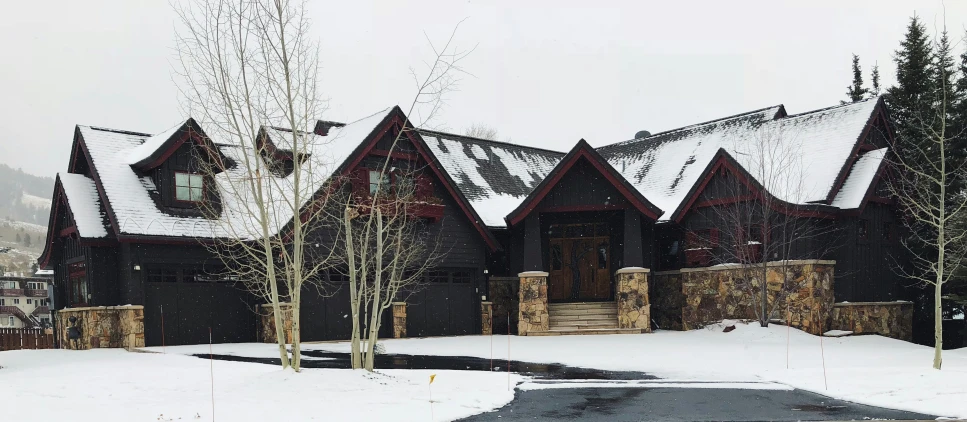 a snow covered home with the door open