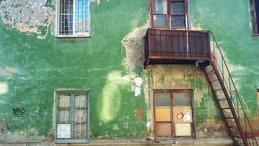 a balcony on a building with peeling paint