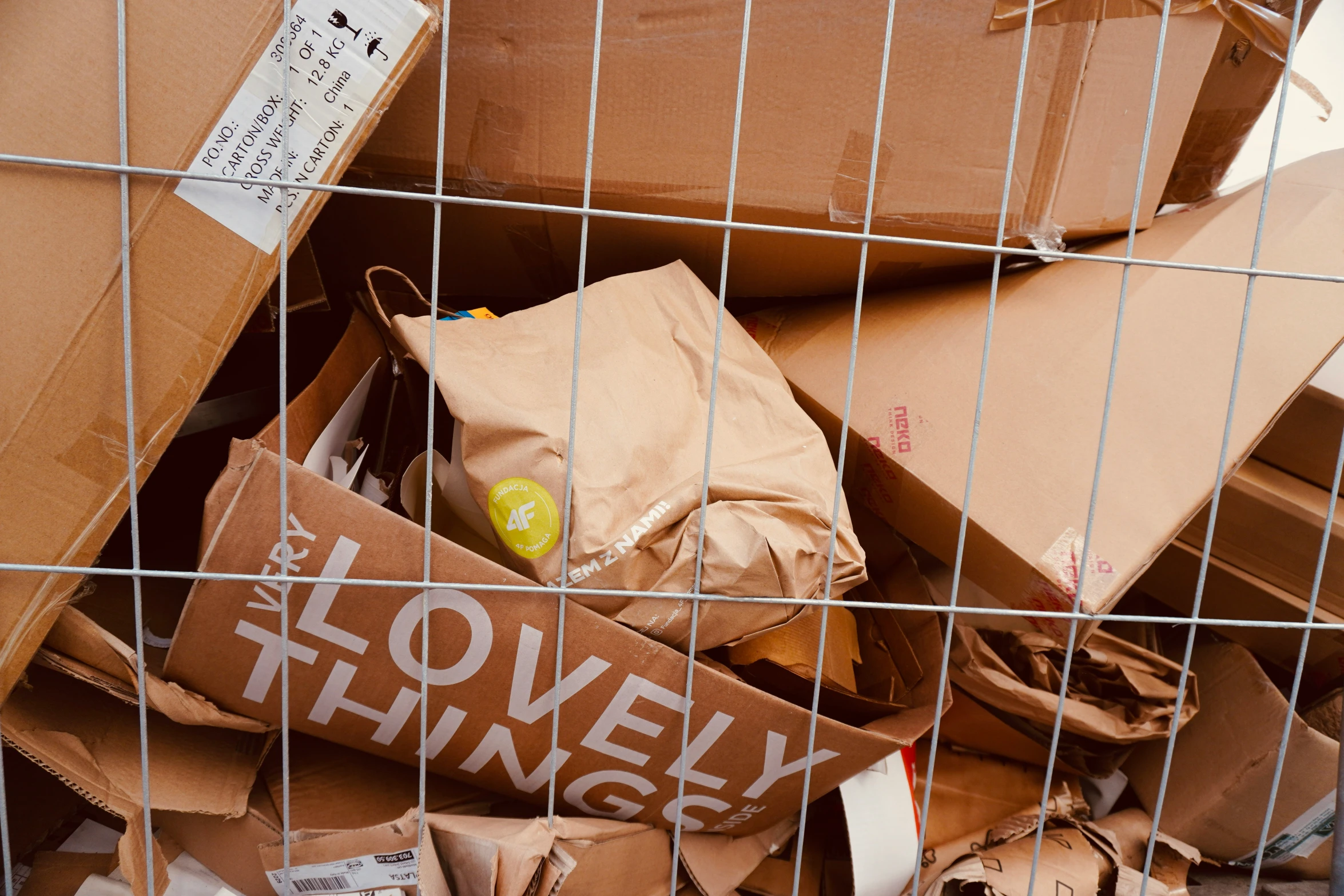 many cardboard boxes are stacked in a metal wire basket