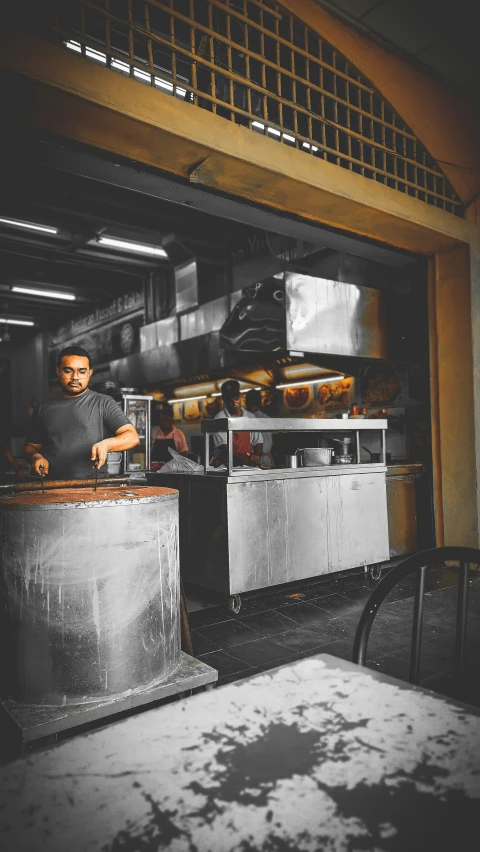 a man standing next to some silver counter