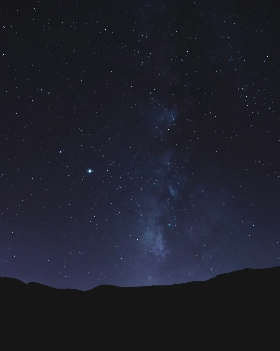 the stars on a clear night sky over a valley