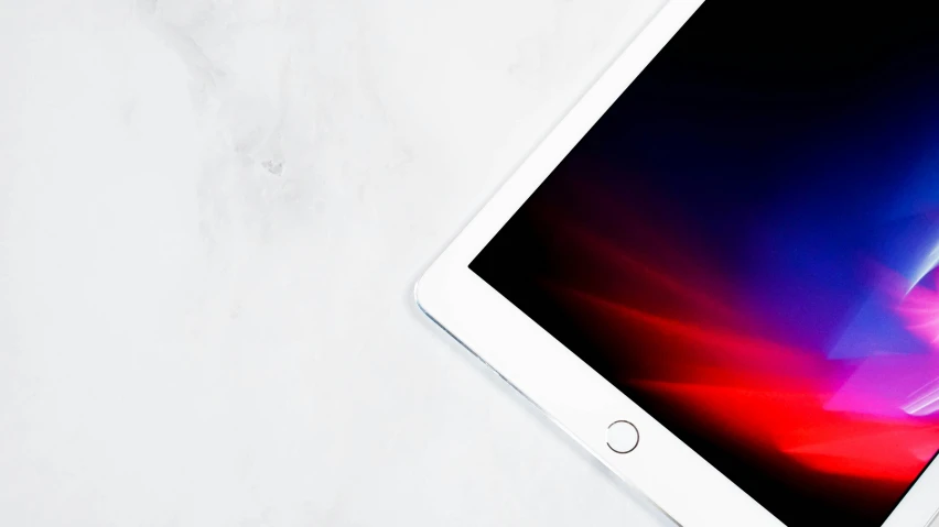 an apple ipad pro is laying on a white surface