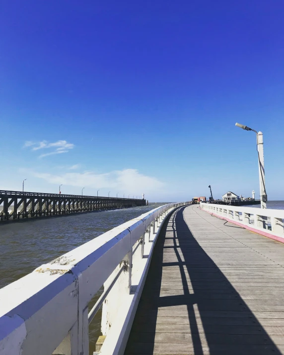 a long pier stretching into the ocean