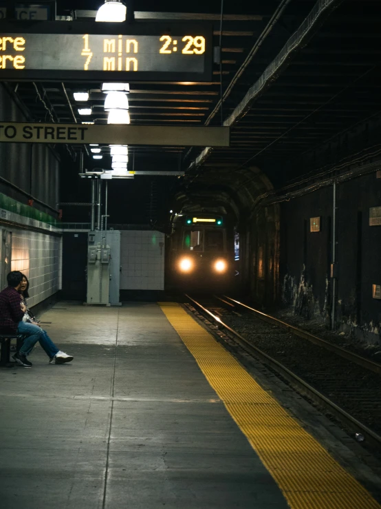 a train coming down the tracks in the station