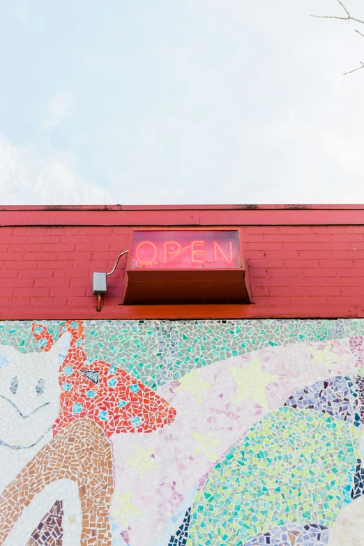 the building is painted with images and has a colorful roof