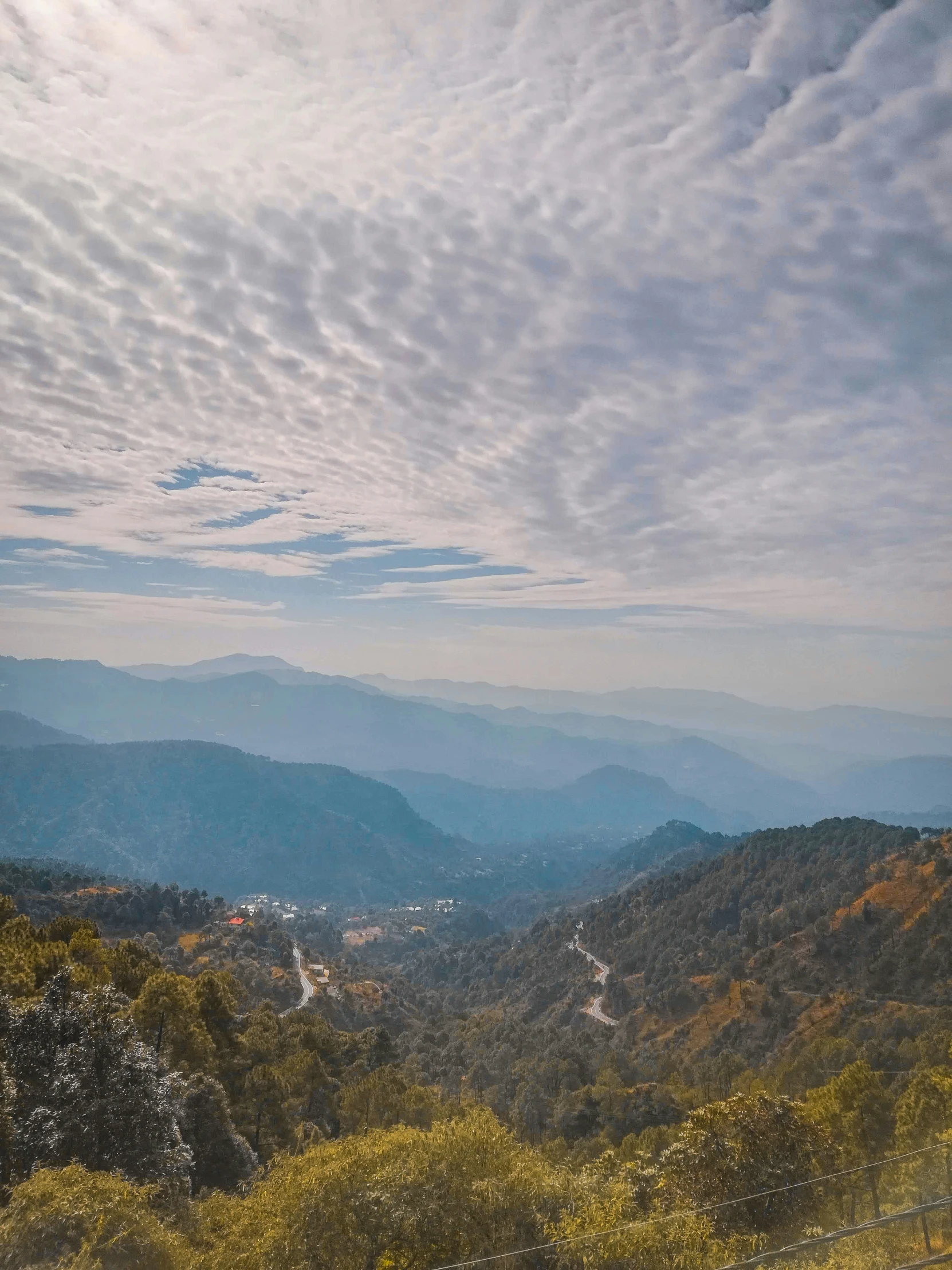 a view of a valley that is in the middle of mountains