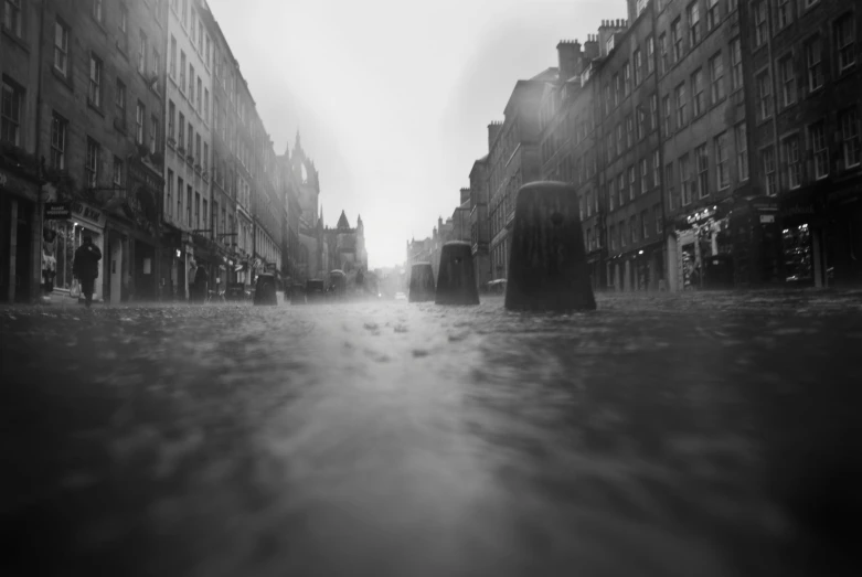 a person riding down a street with buildings on either side