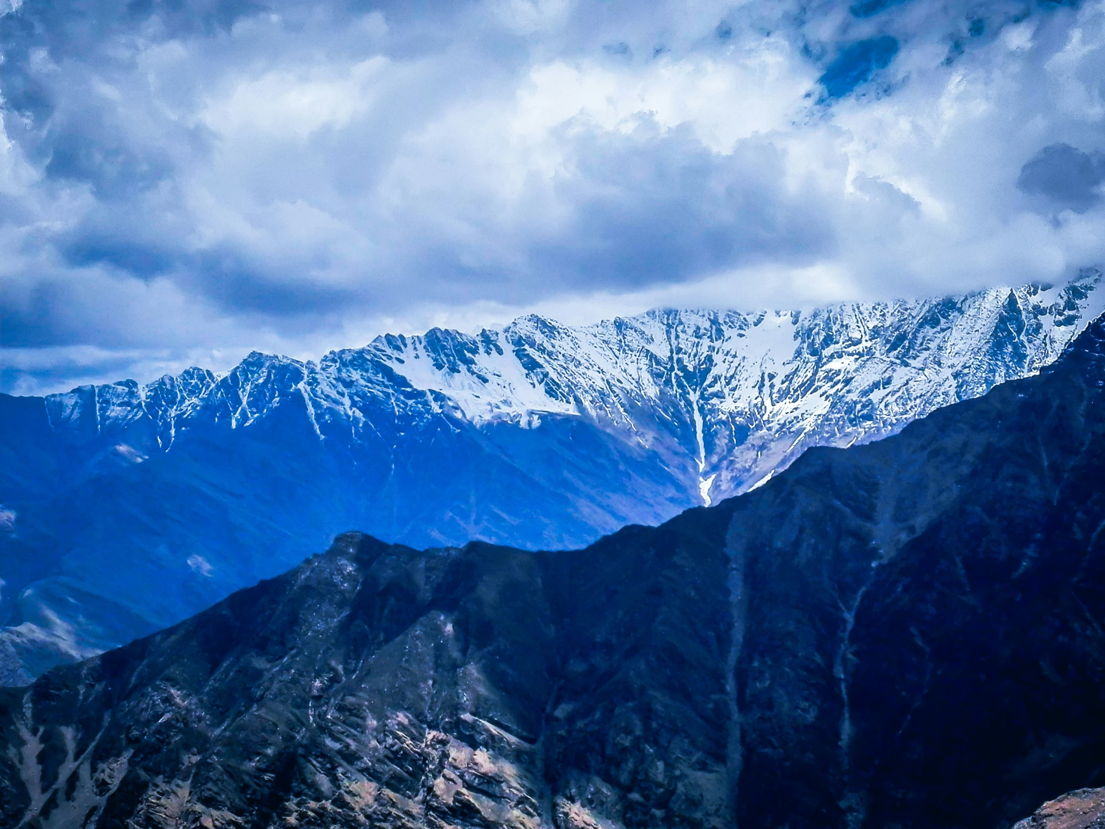 a view of a mountain range with snow covered peaks