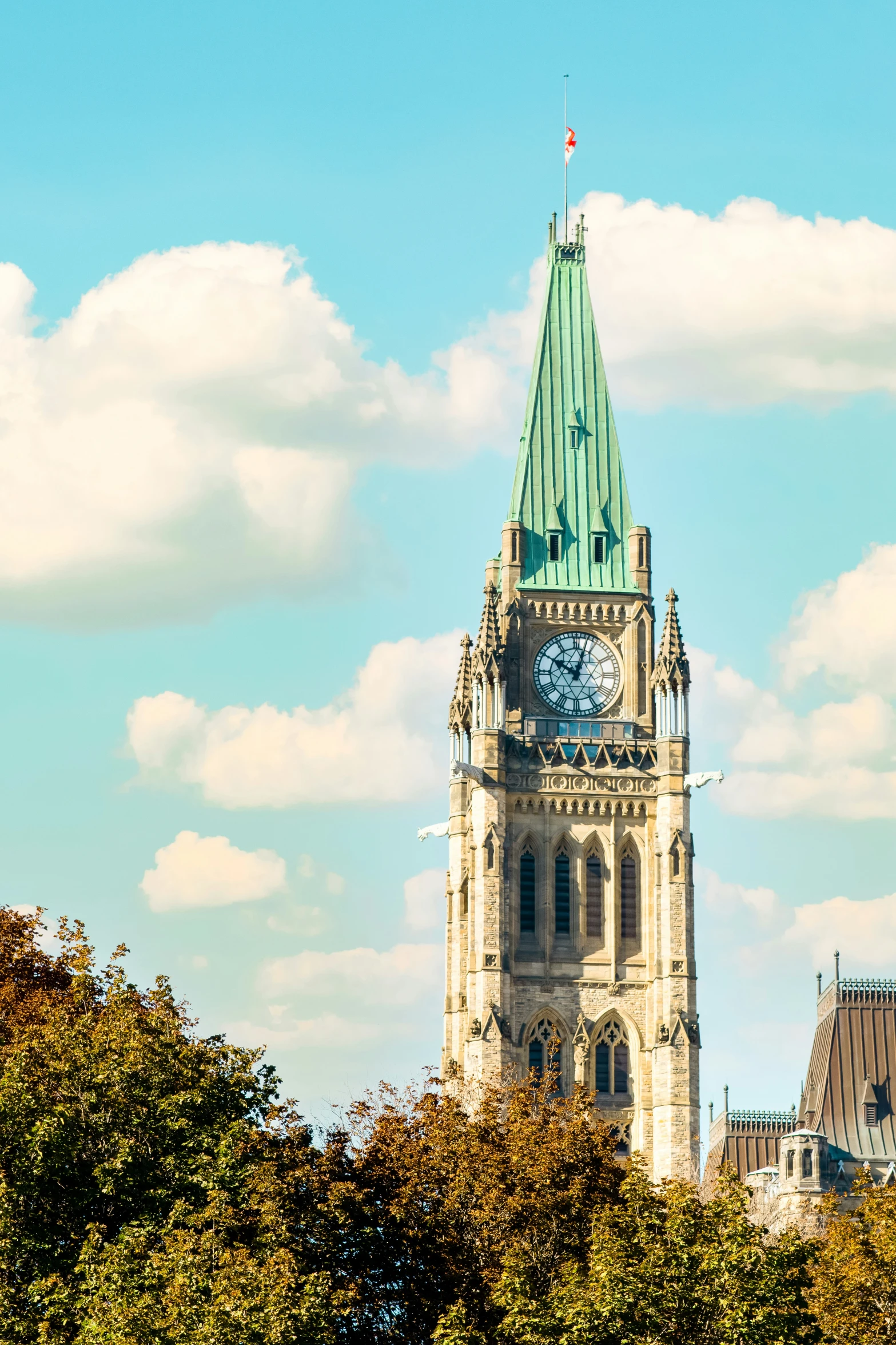 a large cathedral with a clock is seen on a clear day