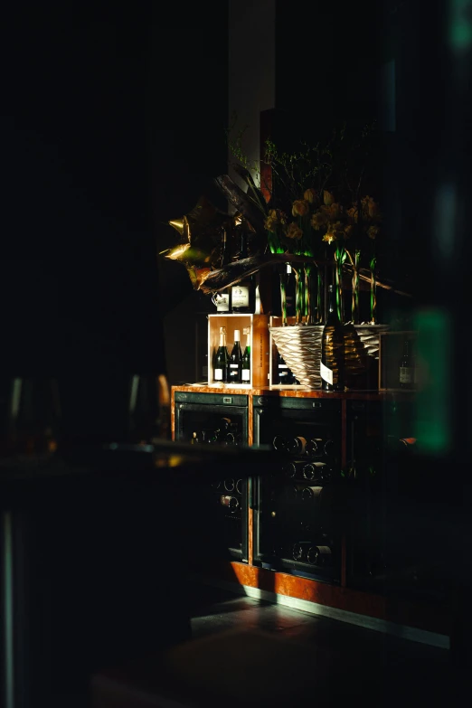 a shelf of liquor bottles in the dark