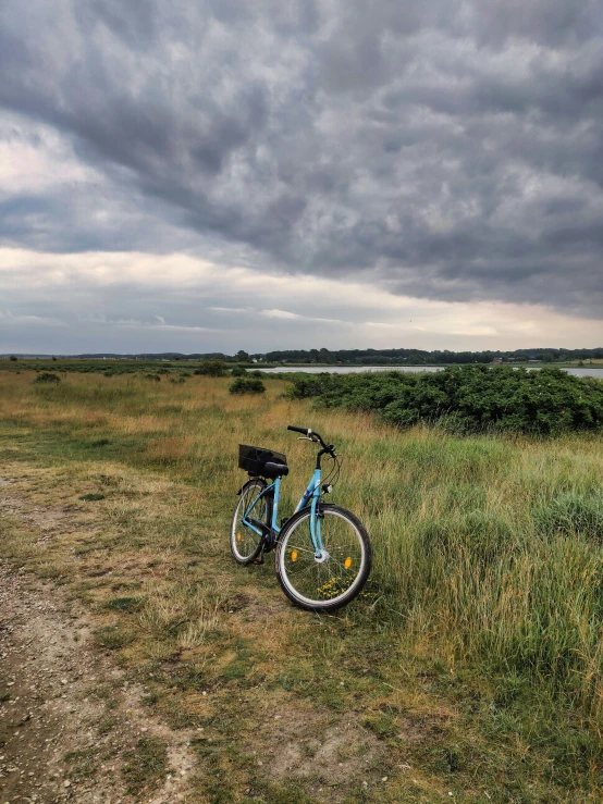 a bike in the distance standing on a field