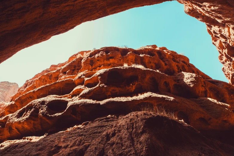 the view through an arch into a mountain in the desert