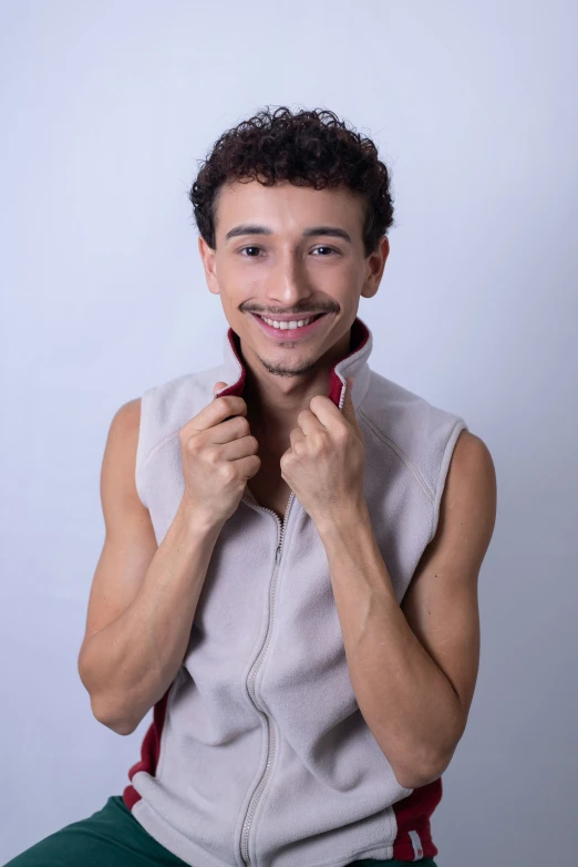 a young man with a mustache poses for a picture