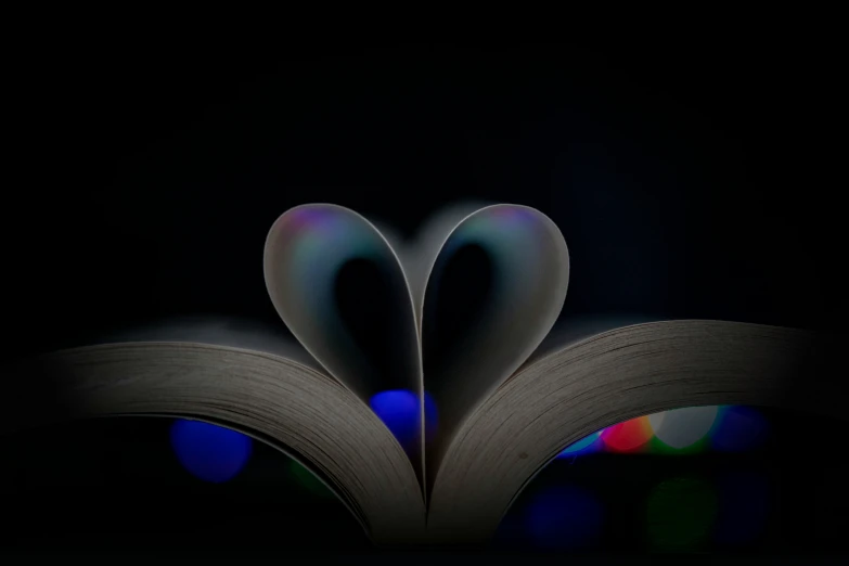 the open book has a colorful light coming out of it