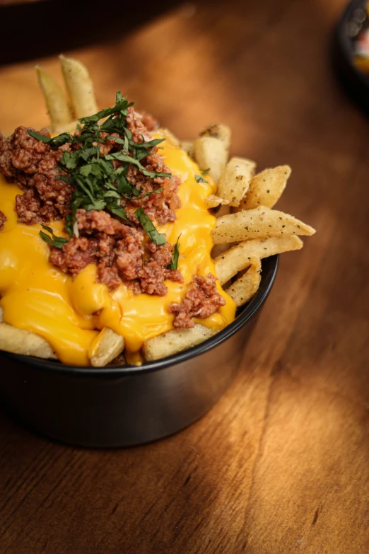 a tasty looking dish with fries, meat and cheese