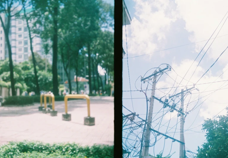 two pographs of electric poles and trees in front of buildings