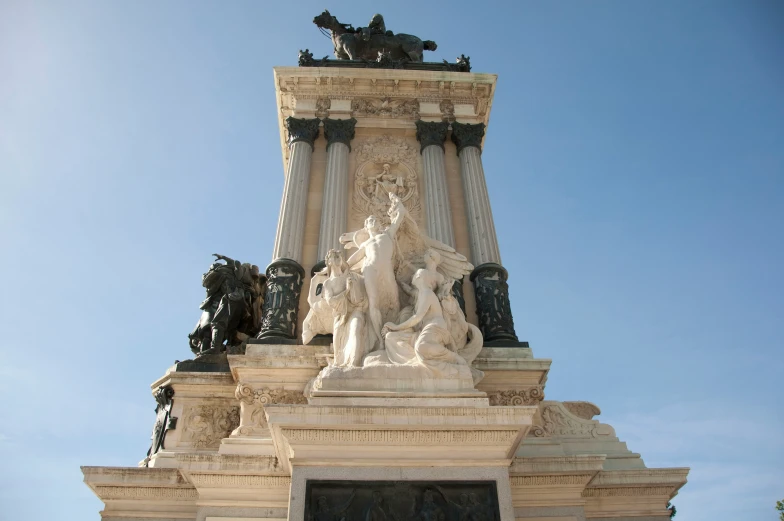 statue and columns on a building with blue sky