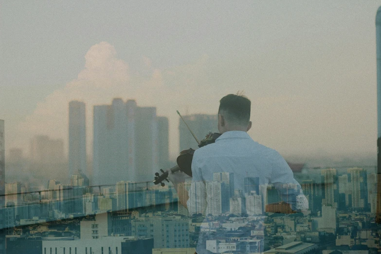 a man looking out into the city skyline