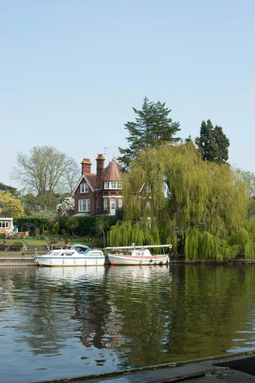 two boats moored in the water at a lake