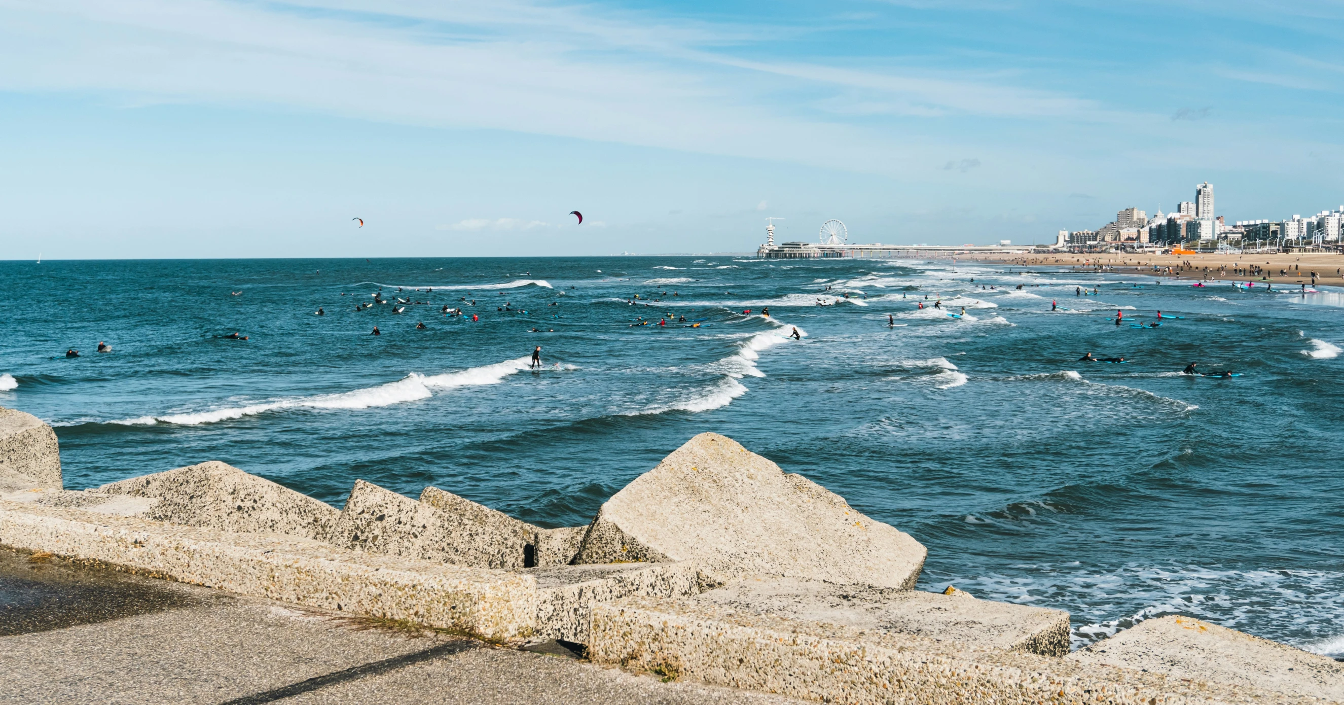 several people are playing on the beach in the water