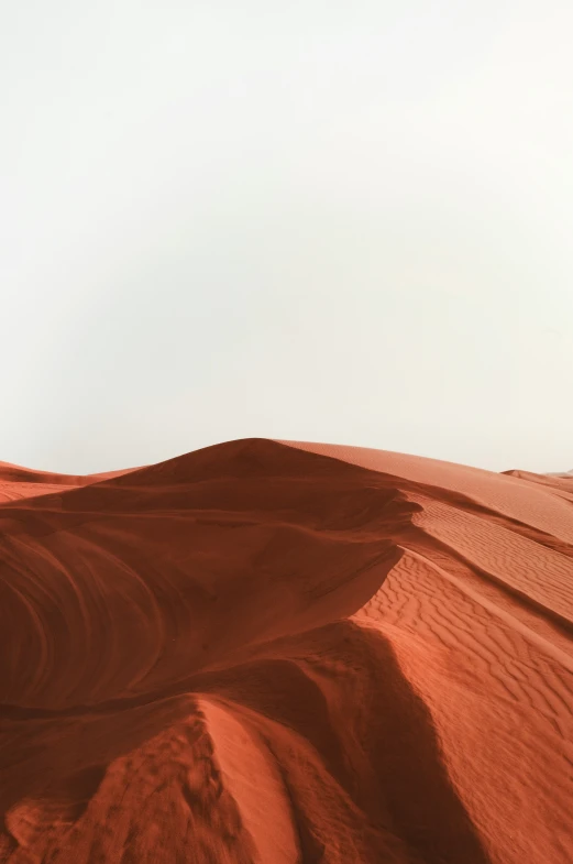 a hill with brown soil in the desert