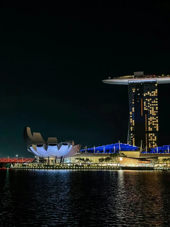 a large building on the water that looks like a city