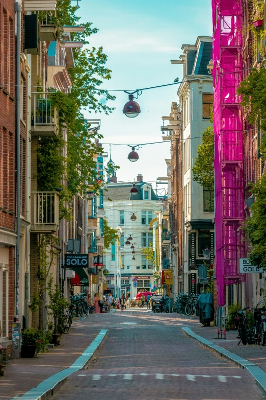 a street lined with parked bicycles next to tall buildings