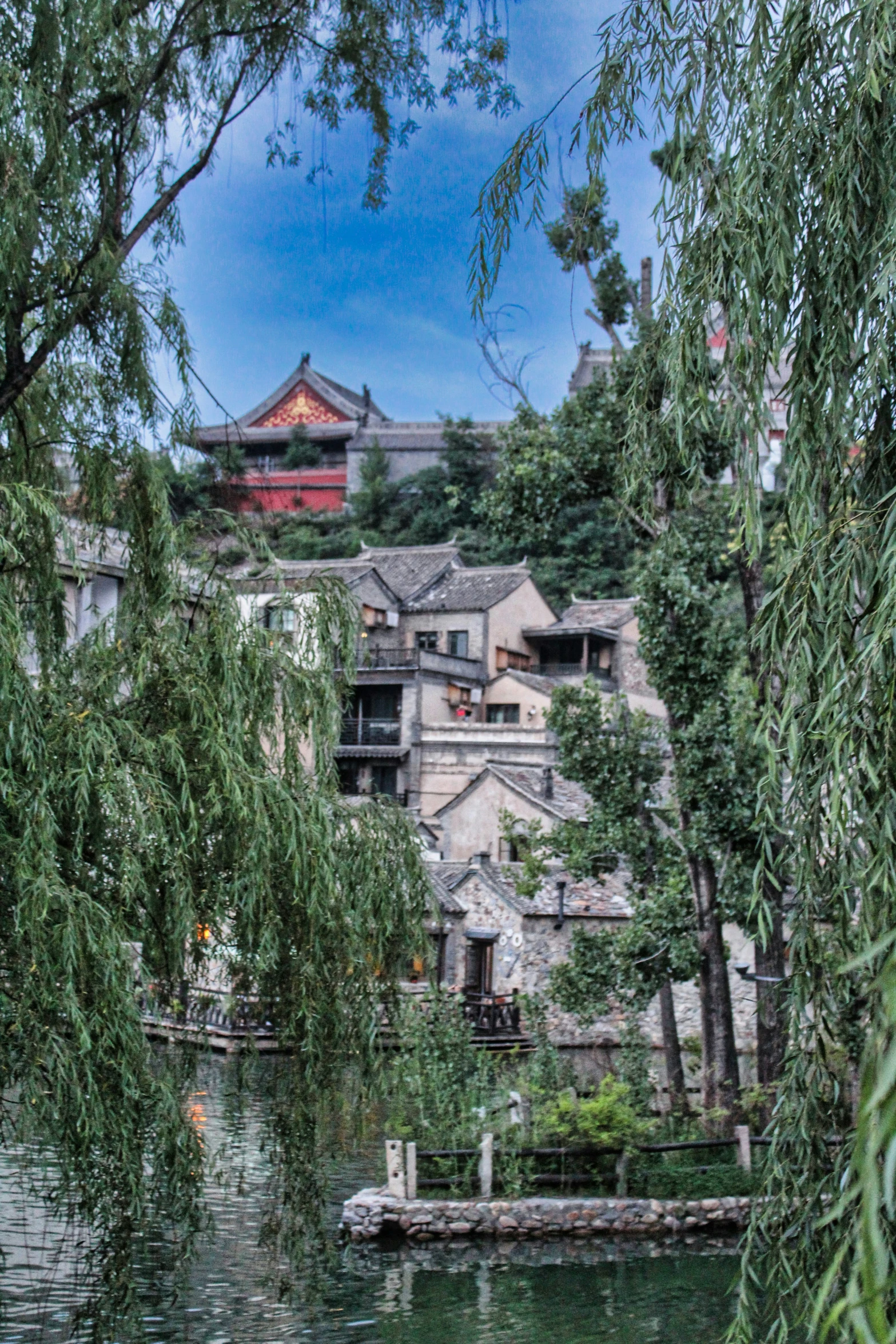 a boat traveling down a river past a building