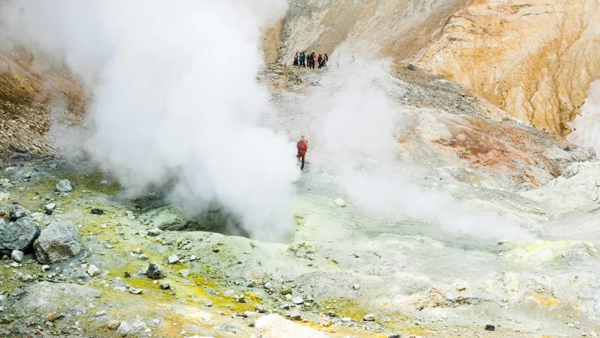 there are two people standing near the  spring