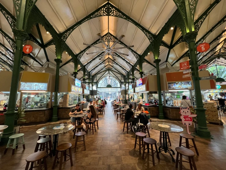 the inside of a building with tables and chairs