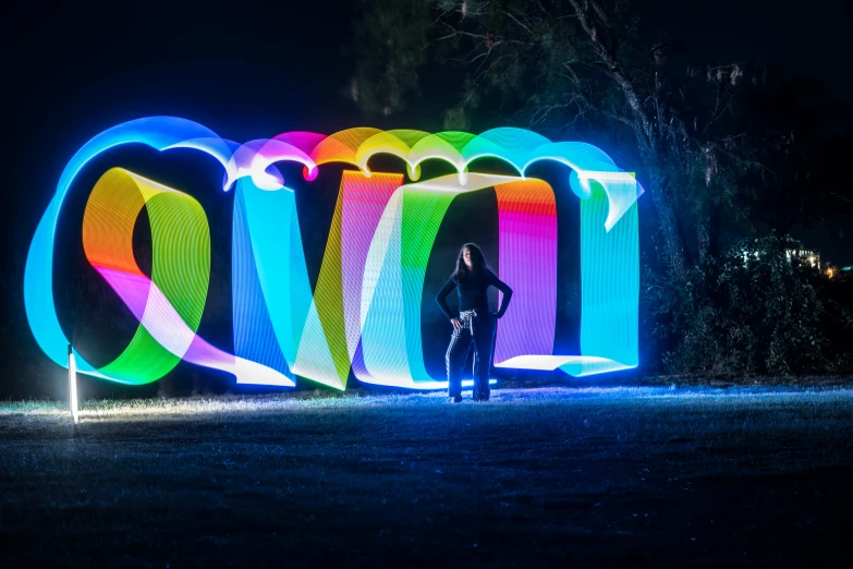 a woman is standing in front of colorful lights