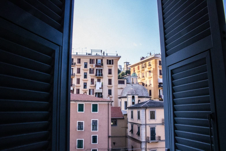 the view out a window at an apartment building