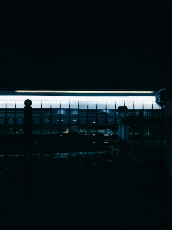 a train on the track in the dark with its lights on