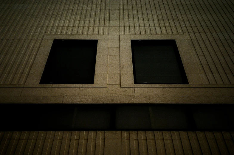 the shadow shows the bottom half of a building with three windows