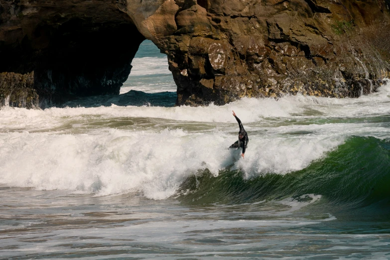 a person riding a wave on top of a surfboard