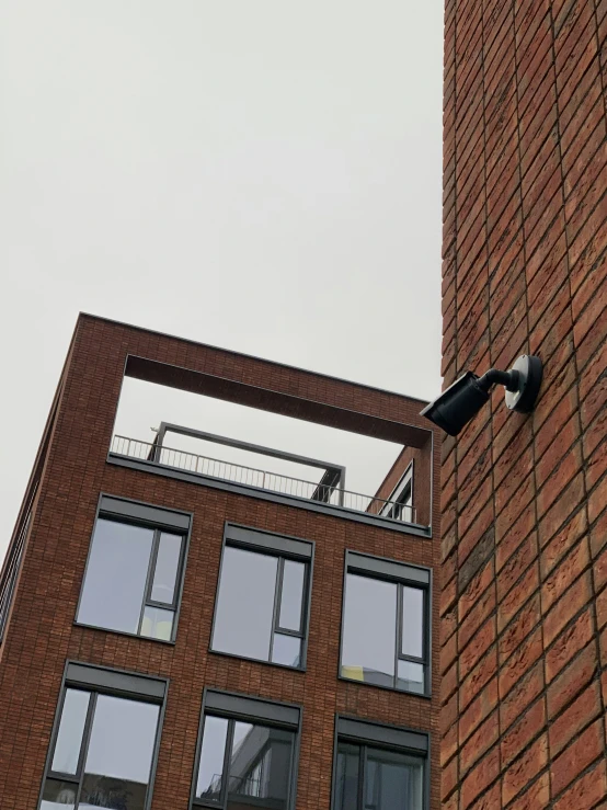 a street sign hanging off the side of a tall building