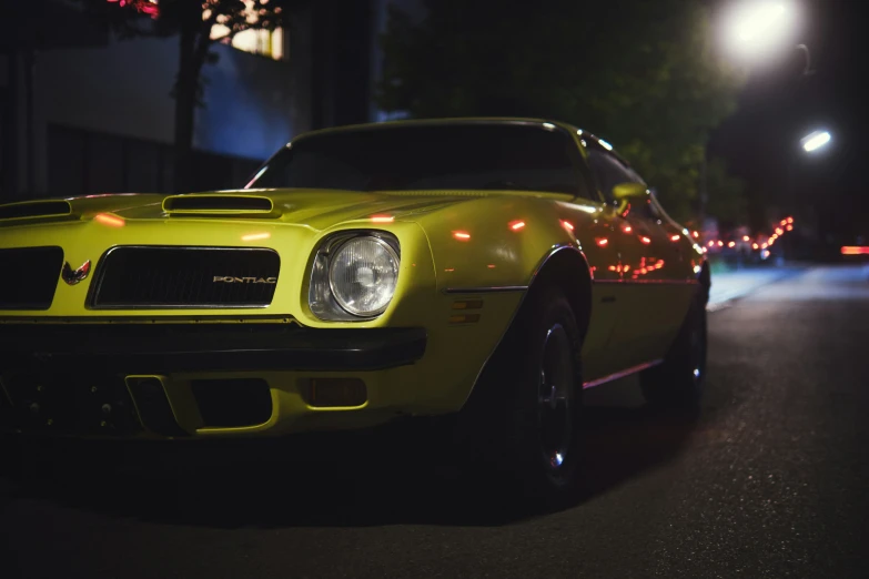 a sports car is parked on a dark street