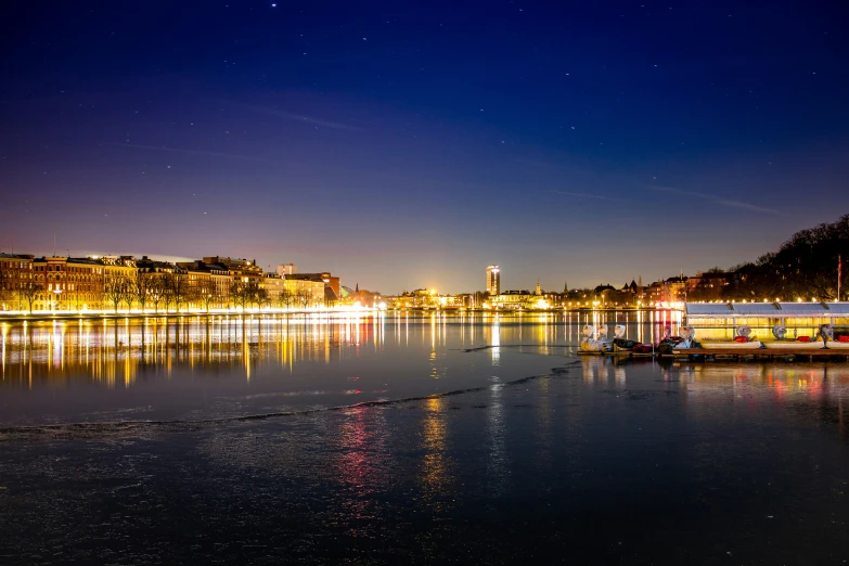 a long boat is out on the water at night