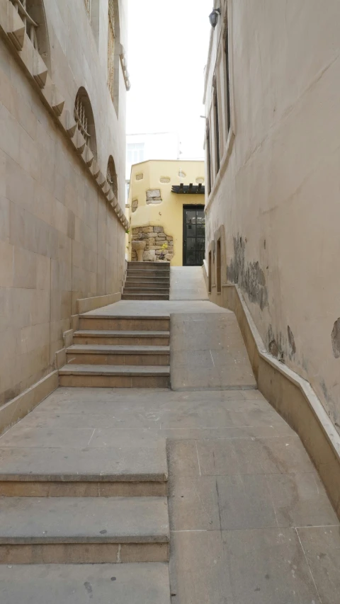 some stairs going up into a yellow building