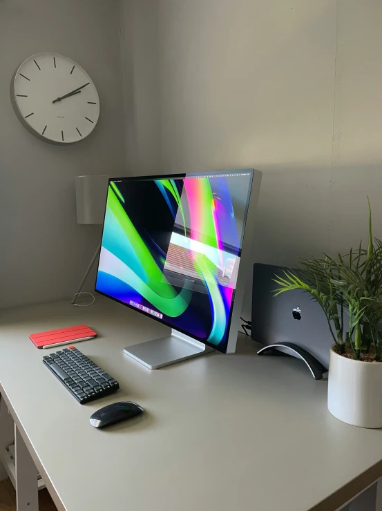 the white desk is holding a desktop computer and keyboard