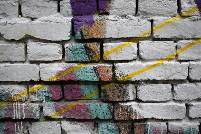 an old brick wall with graffiti on it