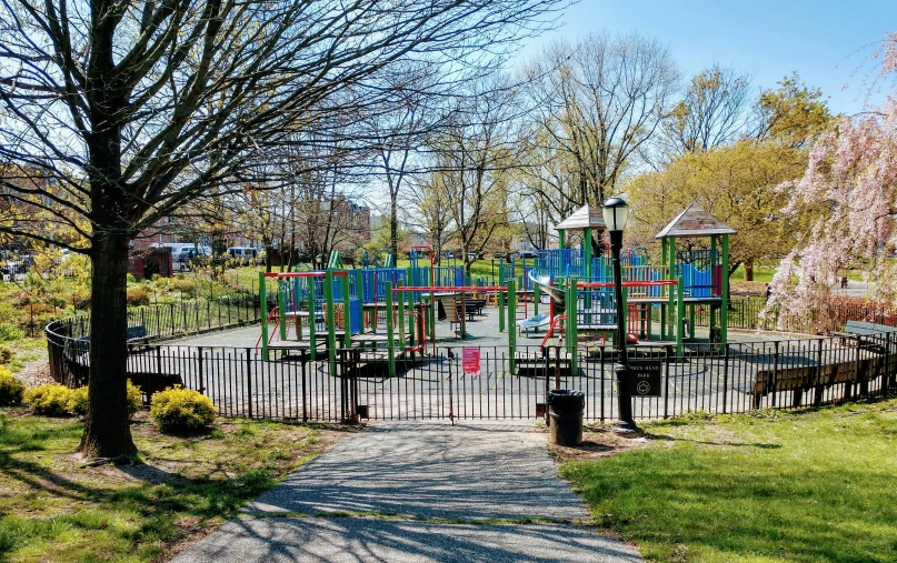 a walkway leads to a play area in the park