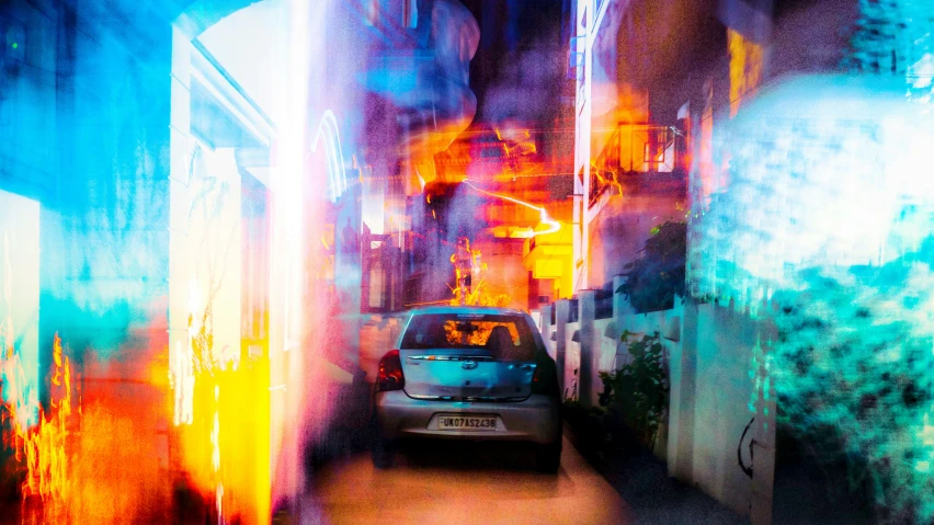 a car parked between some buildings with some light painting