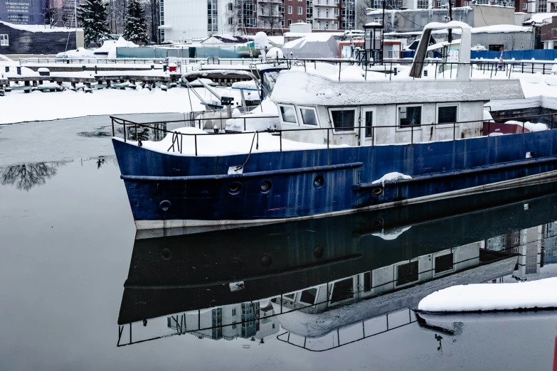 a boat floating in a body of water covered in snow