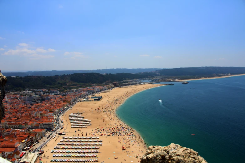 view from the top of a hill to a crowded beach