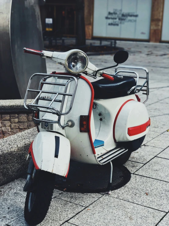 a close up of a white scooter parked on the street