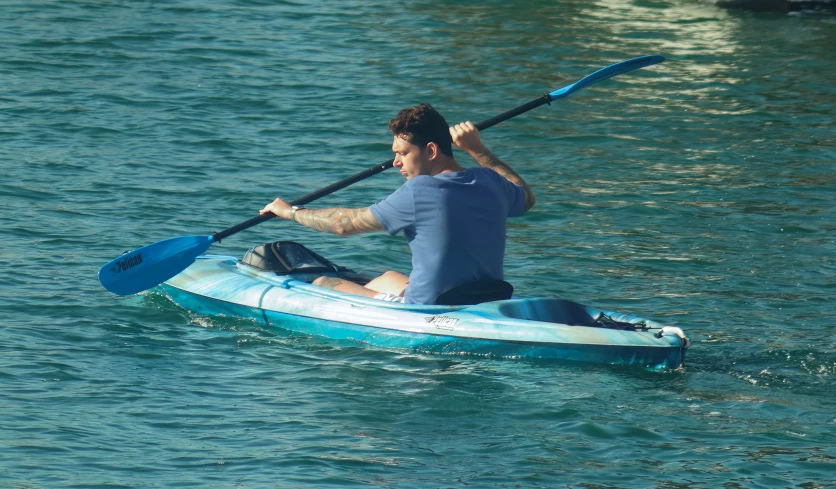 a man in the water with a paddle board