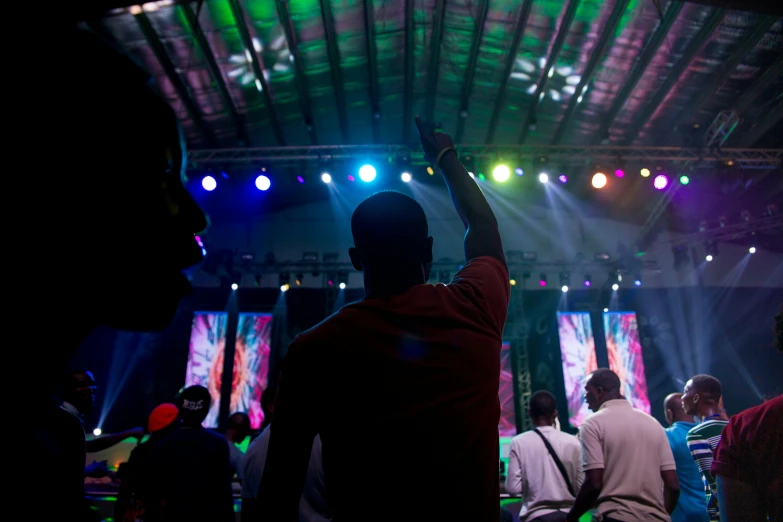 people are gathered inside an auditorium at a party